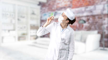 Beautiful medical woman doctor in uniform. Studio painted background. Concept of profitable health...