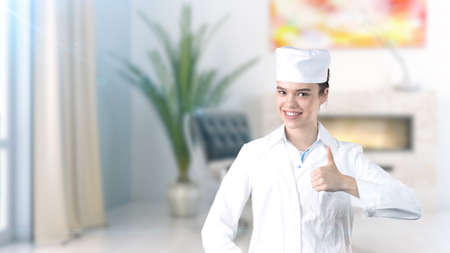 Beautiful medical woman doctor in uniform. Studio painted background. Concept of profitable health care.の写真素材