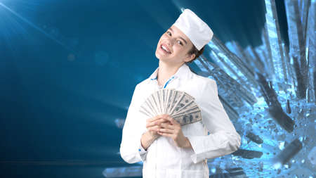 Beautiful medical woman doctor in uniform. Studio painted background. Concept of profitable health care.の写真素材