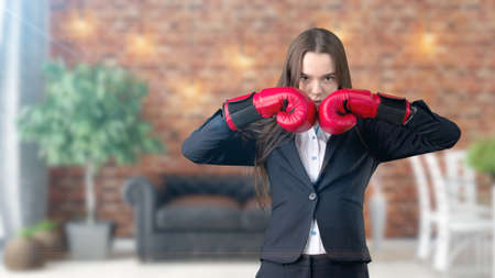 Young beautiful business woman and creative designer standing over blured interior backgroundの写真素材
