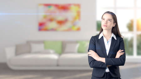 Young beautiful business woman and creative designer standing over blured interior backgroundの写真素材