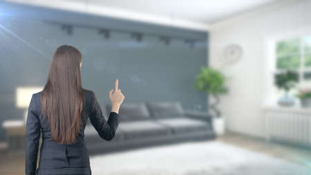 Young beautiful business woman and creative designer standing over blured interior backgroundの写真素材