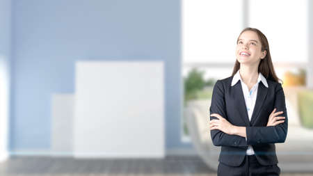 Young beautiful business woman and creative designer standing over blured interior backgroundの写真素材