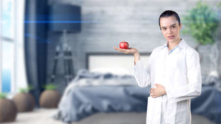 Beautiful medical woman doctor in uniform. Studio painted background. Concept of profitable health care.の写真素材