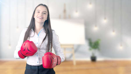 Young beautiful business woman and creative designer standing over blured interior backgroundの写真素材