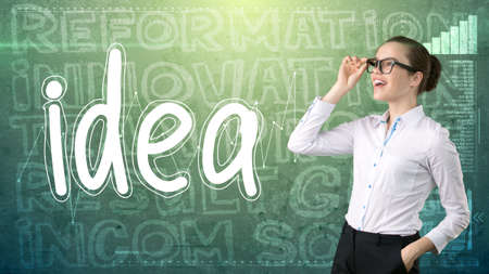 Beauty businesswoman on painted background with marketing words. Advertising, investment and business plan conceptの写真素材