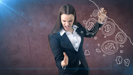 Successful business woman standing near btc. She needs to buy or sell Bitcoin. Concept of virtual criptocurrency.の写真素材