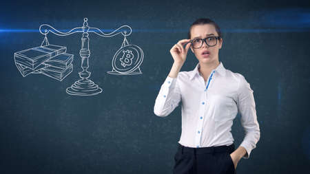 Lucky cute lady and bitcoin investment. Concept of mining and virtual criptocurrency. Successful money making.の写真素材