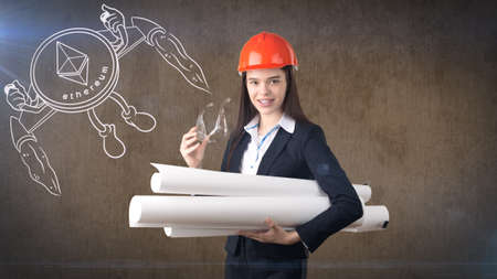 Beauty young business woman standing near sketches of Ethereum crypto currency coin. Business concept of Ethereum icon.の写真素材