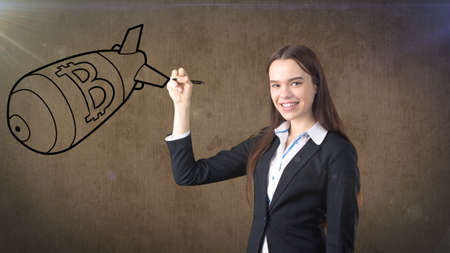 Beauty business woman standing near btc. Successful Bitcoin investment. Concept of virtual criptocurrency.の写真素材