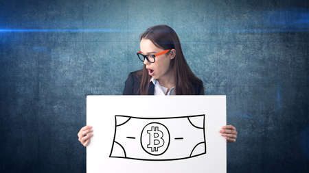 Beauty business woman standing near btc. Successful Bitcoin investment. Concept of virtual criptocurrency.の写真素材