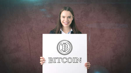 Beauty business woman standing near btc. Successful Bitcoin investment. Concept of virtual criptocurrency.の写真素材