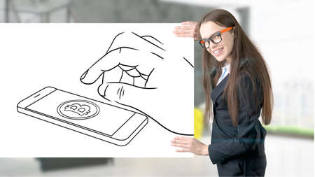 Surprised smiling young woman wearing a suit and looking at a cryptocurrency sketch on a design flat wall. Concept of Bitcoin risk.の写真素材