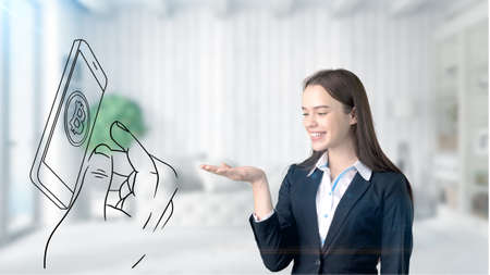 Surprised smiling young woman wearing a suit and looking at a cryptocurrency sketch on a design flat wall. Concept of Bitcoin risk.の写真素材