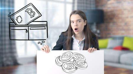 Surprised smiling young woman wearing a suit and looking at a cryptocurrency sketch on a design flat...