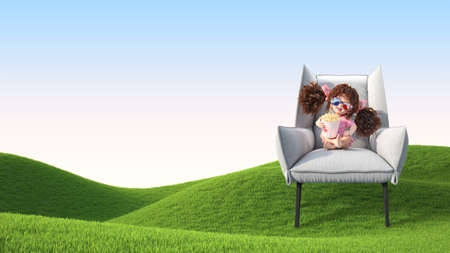 A little girl in 3D glasses sitsの写真素材