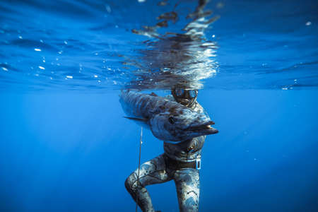 A spear fisherman with a prized wahoo