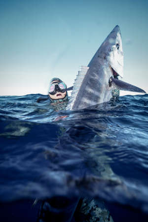 A spear fisherman with a prized wahooの写真素材