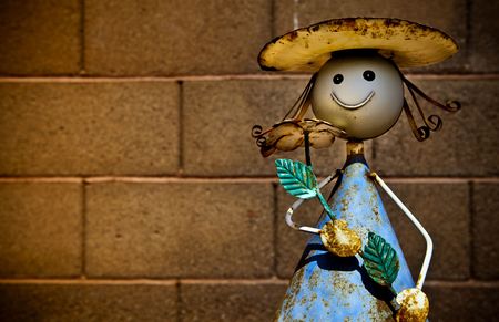 Garden flower girl against a brick wallの写真素材
