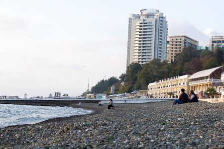SOCHI, RUSSIA - November 06, 2016: The sea stone beach against modern multi-storey buildings and hotels. Sochi, Russiaのeditorial素材