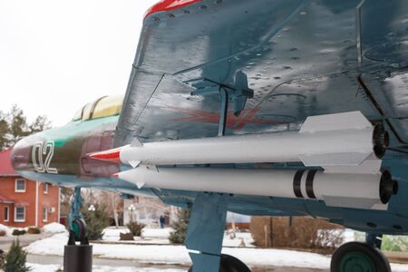 VOLGOGRAD, RUSSIA - February 24, 2017: The rocket with a red tip is attached to a wing of the disguised plane with a star in the woodのeditorial素材