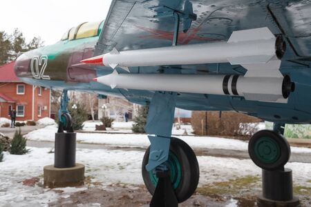 VOLGOGRAD, RUSSIA - February 24, 2017: The rocket with a red tip is attached to a wing of the disguised plane with a star in the woodのeditorial素材
