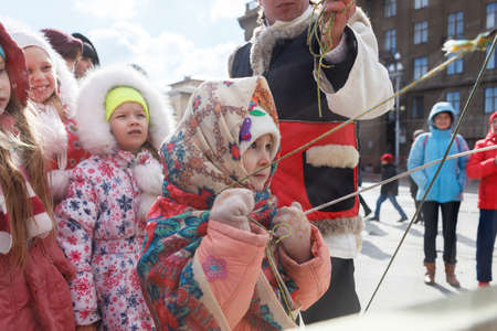 VOLGOGRAD, RUSSIA - February 26, 2017: The girl in a scarf plays on bellsのeditorial素材