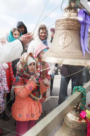 VOLGOGRAD, RUSSIA - February 26, 2017: The girl in a scarf plays on bellsのeditorial素材