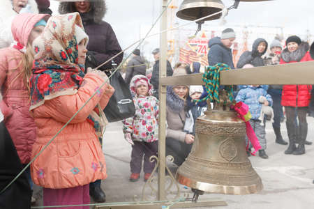 VOLGOGRAD, RUSSIA - February 26, 2017: The girl in a scarf plays on bellsのeditorial素材