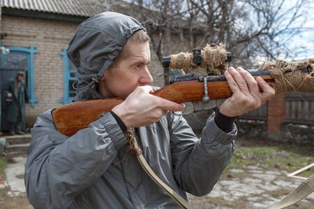 The modern man looks in a sight of a rifle of World War II, Mosin's rifle