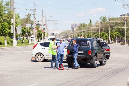 VOLGOGRAD, RUSSIA - May 28, 2017: Drivers talk argue on the road after accident with cars in are...