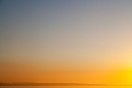 The red sky early in the morning over the seaの写真素材