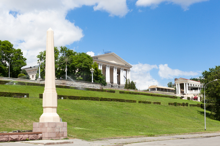 VOLGOGRAD, RUSSIA - June 25, 2017: The ancient building of musical theater with columns against the background of a green lawn with a grass and the blue sky in the summerのeditorial素材