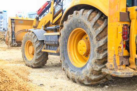 VOLGOGRAD, RUSSIA - April 23, 2018: The yellow tractor in work earthwork with sand, at construction of the Arena stadium, on Mamayev Kurgan in Volgogradのeditorial素材