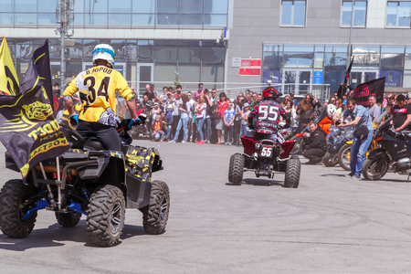 VOLGOGRAD, RUSSIA - May 5, 2018: The motorcyclist carries out tricks on the four-wheel motorcycle the ATV, on the square in front of Europe shopping Centerのeditorial素材