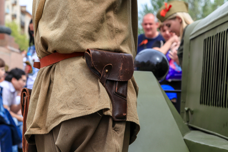 VOLGOGRAD, RUSSIA - May 9, 2018: The person keeps the PPSh submachine gun of Shpagin in a green...