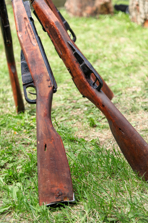 VOLGOGRAD, RUSSIA - May 9, 2018: Old Soviet weapon of a rifle is cost having leaned the friend against the friend on a green grass in marching situationのeditorial素材