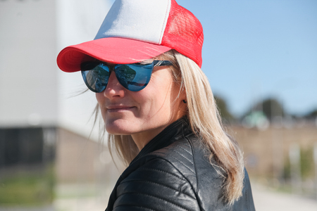 The woman in jeans, a baseball cap, a leather jacket, 
sunglassesの写真素材