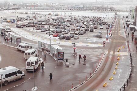 The road with the parking of cars and a stop of public transportのeditorial素材