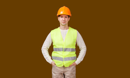 The man in a construction helmet and a vest in a fullface