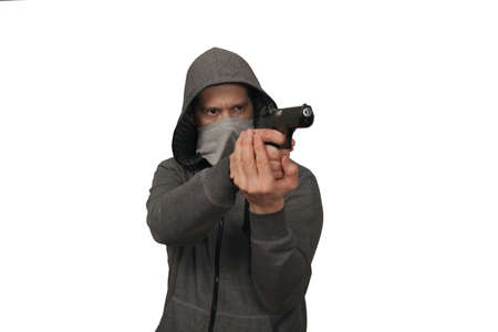 The man shoots with the gun. A white background, a portrait on a belt
