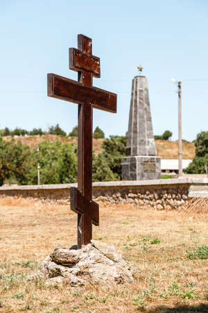 KERCH, RUSSIA - July 2, 2019: A cross against the backdrop of a monument to the brotherly grave of the Great Patriotic War, in Kerch, Crimeaのeditorial素材