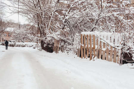 VOLGOGRAD, RUSSIA - 27 December, 2018: The person goes on the winter dirt road along a wattled fenceのeditorial素材