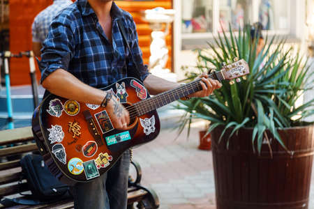 KERCH, RUSSIA - June 30, 2019: Street musician plays guitar in summerのeditorial素材