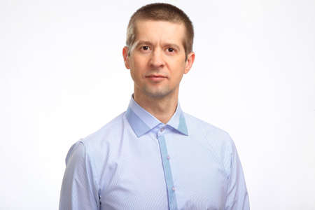 a happy man in a light shirt looks at the camera. Isolated, on white