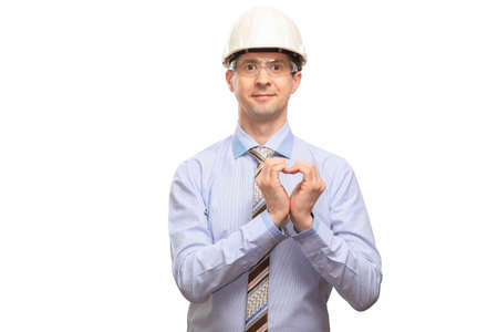 Funny man in a standing helmet, glasses, office shirt and tie holds his hands in the form of a...