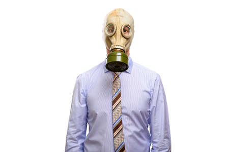 A protected businessman in a gas mask, shirt and tie looks into the camera. Isolated, on whiteの写真素材
