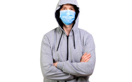 Sports man in hooded jacket crossed hands, isolated, whiteの写真素材