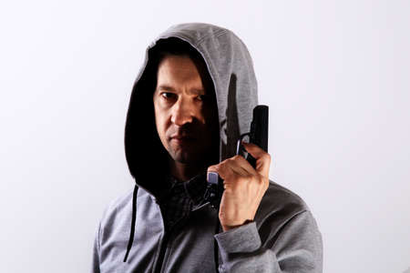 Man with gun and hood on his head, major planの写真素材