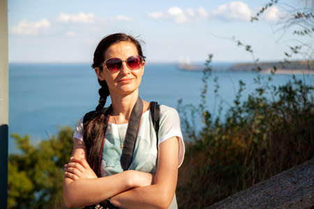 Thin girl photographer in nature, by the seaの写真素材